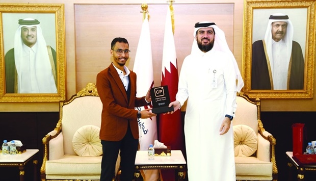 Qatarat's Gaafer receiving the CP trademark from QC's Fakhroo.