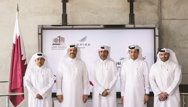 Abdulla Nasser al-Naemi and Dr Khaled al-Khanji, along with other officials from AZF and QU.