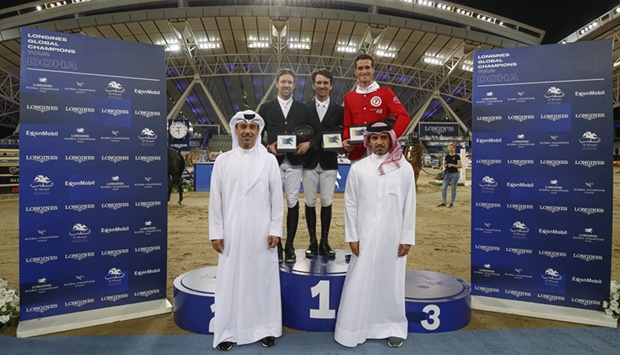 Qatar Equestrian and Modern Pentathlon Federation President Badr Mohamed al-Darwish (right) and Event Director of LGCT Doha and Commercial Manager at Al Shaqab Omar al-Mannai pose with top three finishers of the Longines Global Champions Tour CSI5* 1.55m class on Thursday.