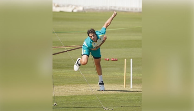 Australian captain Pat Cummins bowls during a net practice session at the Pindi Cricket Stadium.