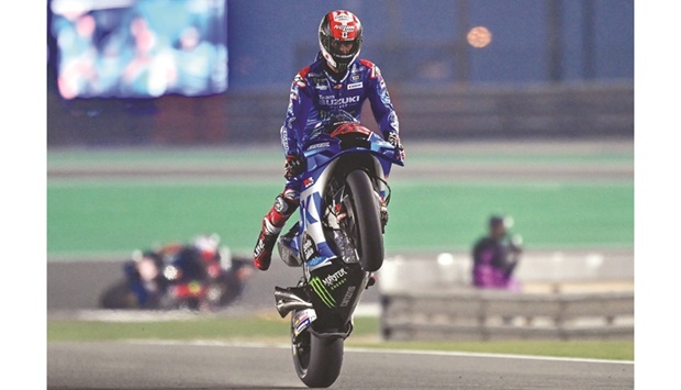 Spainu2019s Alex Rins of Team Suzuki Ecstar celebrates with a wheelie after setting the fastest time during the second free practice session at MotoGP Grand Prix of Qatar at the Losail International Circuit on Friday. Photo by: Noushad Thekkayil
