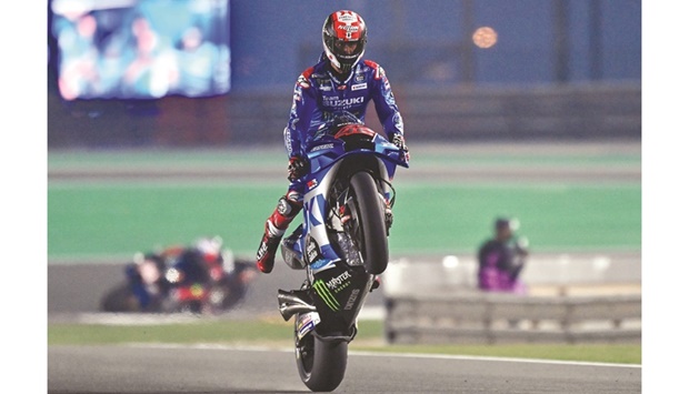 Spainu2019s Alex Rins of Team Suzuki Ecstar celebrates with a wheelie after setting the fastest time during the second free practice session at MotoGP Grand Prix of Qatar at the Losail International Circuit on Friday. Photo by: Noushad Thekkayil