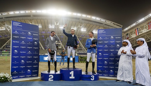 Top three finishers of the 1.55m jump-off class celebrate on the podium on Friday.