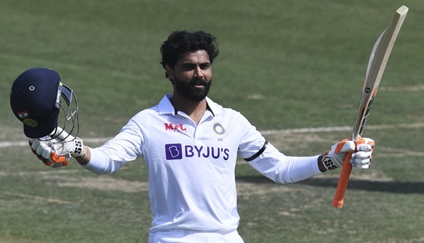 India's Ravindra Jadeja celebrates after scoring a century (100 runs).