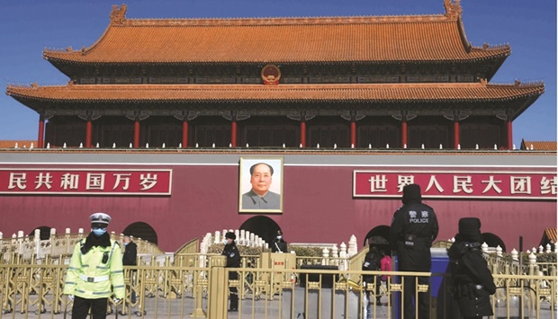 Security personnel patrol in front of the Tiananmen Gate, near the Great Hall of the People ahead of the opening ceremony of the National Peopleu2019s Congress (NPC) in Beijing on  Saturday. China has targeted slower economic growth of around 5.5% this year as headwinds including an uncertain global recovery and a downturn in the countryu2019s vast property sector cast a pall on the worldu2019s second-largest economy.