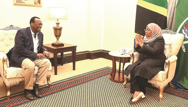 In this handout picture taken and released by Tanzanian State house, Tanzaniau2019s President Samia Suluhu Hassan speaks with the chairman of the Chadema opposition party Freeman Mbowe (left) in Dar es Salaam.