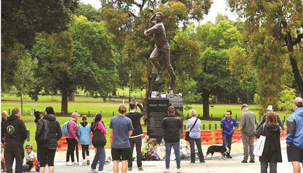 People pay their respects at a statue of former Australian cricket great Shane Warne outside the Melbourne Cricket Ground (MCG) in Melbourne yesterday. (AFP)