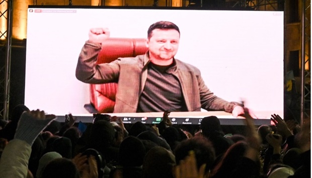 Demonstrators watch an address of Ukrainian President Volodymyr Zelensky on the big screen during a rally in support of Ukraine in Tbilisi on March 4. Vano Shlamov/AFP