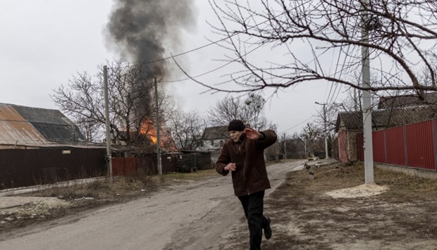 A local resident reacts as a house is on fire after heavy shelling on the only escape route used by locals to leave the town of Irpin, while Russian troops advance towards the capital, in Irpin, Ukraine on March 6. REUTERS/Carlos Barria