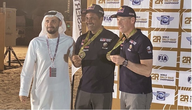 Qataru2019s rally driver Nasser al-Attiyah and his French co-driver Mathieu Baumel being honoured after winning the Distribution Special Stage 2 of the Abu Dhabi Desert Challenge on Monday.