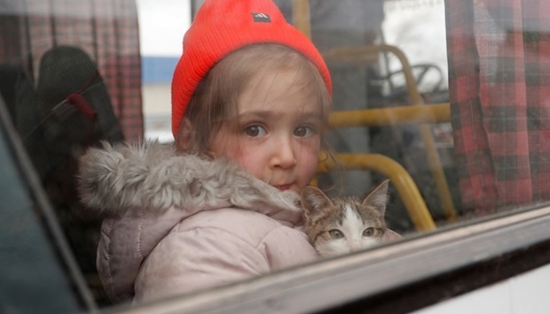Rimma, a three-year-old girl evacuated from Mariupol area, holds a cat in a bus before leaving a refugee camp in the settlement of Bezymennoye for the territory of Russia during Ukraine-Russia conflict in the Donetsk region, Ukraine on March 8. REUTERS/Alexander Ermochenko