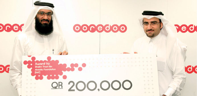  Mohamed Alansari of Ooredoo with Ali al-Kuwari of RAF.