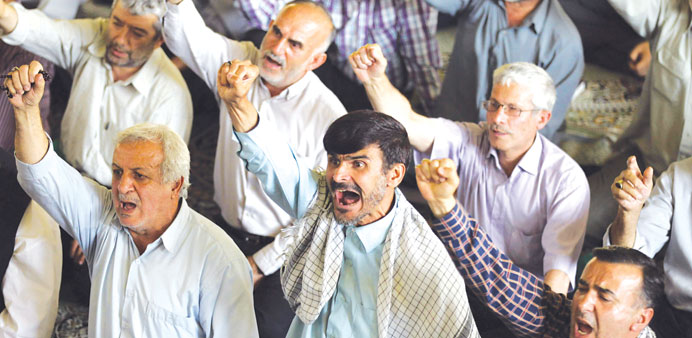    Iranians shout slogans against the US and Israel as they attend Friday prayers yesterday at the university of Tehran.