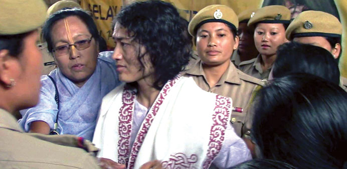 Rights activist Irom Sharmila is led by policewomen after her rearrest in Imphal yesterday