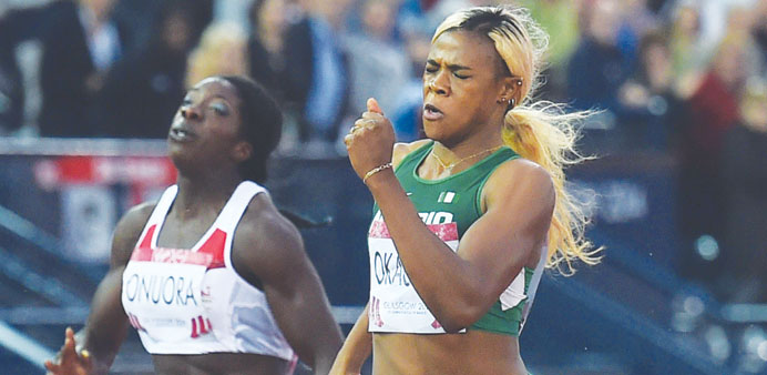 Nigeriau2019s Blessing Okagbare (right) powers home to win gold in the womenu2019s 200M at Hampden Park in Glasgow, Scotland. (AFP)