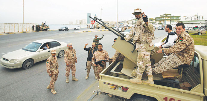  Soldiers are seen at a street in Tripoli yesterday. 