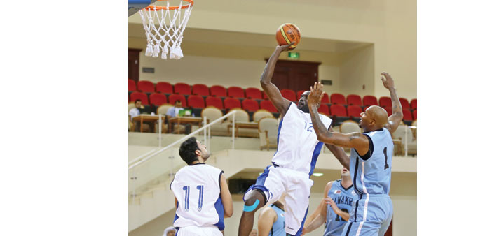 Al Khoru2019s Moustapha Niang goes for the basket against Al Wakrah in their Qatar Basketball League  match yesterday at the Al Rayyan Sports Club. At lef