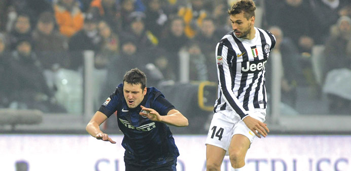 Inter Milanu2019s Zdravko Kuzmanovic (left) is tripped by Fernando Llorente of Juventus during their match in Turin. (Reuters)