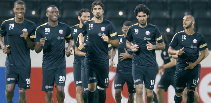 Qatar players in action during a training session in Doha yesterday.
