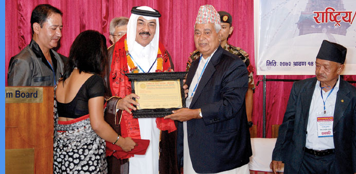  Qataru2019s ambassador to Nepal, Ahmed Jassim al-Hamar, receiving the award.