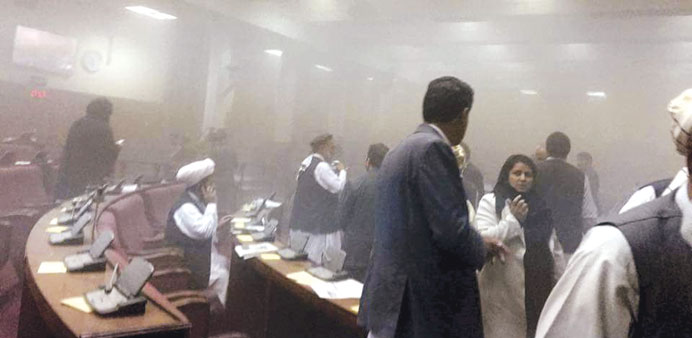 Members of parliament are evacuated after an attack on the Afghan parliament building in Kabul yesterday.