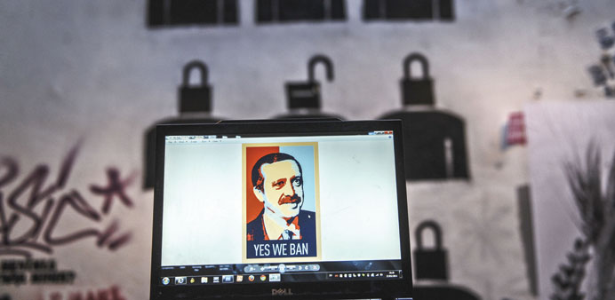 A view of a computer screen showing a digital portrait of Erdogan in front of graffiti in Istanbul. Turkey has banned YouTube, a week after banning Tw