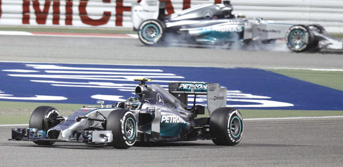 Mercedes driver Nico Rosberg of Germany (front) drives ahead of team-mate Lewis Hamilton of Britain during the qualifying session of the Bahrain F1 Gr