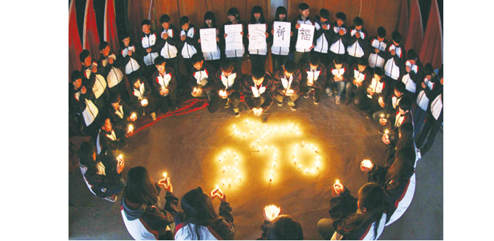High school students holding candles during a vigil for passengers of  MH370 in Lianyungang, east Chinau2019s Jiangsu province, yesterday.