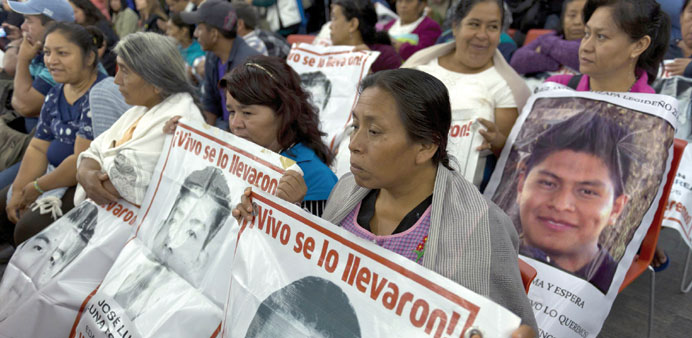 Relatives and friends of the 43 missing students wait before experts of the Inter-American Commission on Human Rights (IACHR) designated to investigat