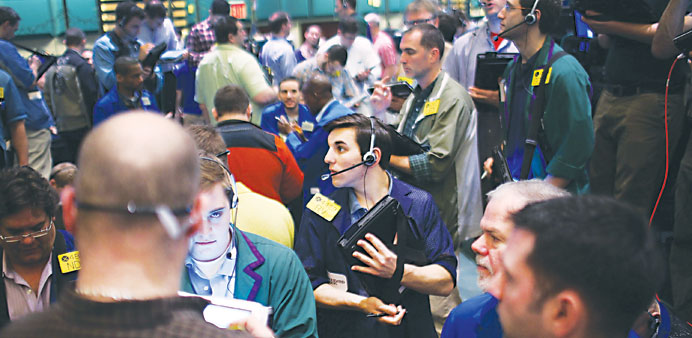 Traders work on the floor of the US oil  futures market. Oil prices fell yesterday.