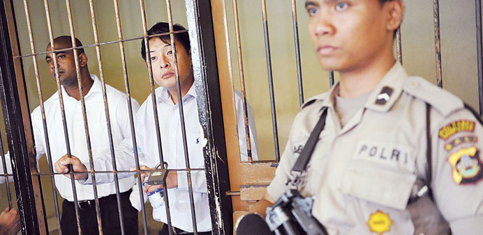 File photo shows Australian death row prisoners Andrew Chan (centre) and Myuran Sukumaran (left) in a holding cell waiting to attend a review hearing 