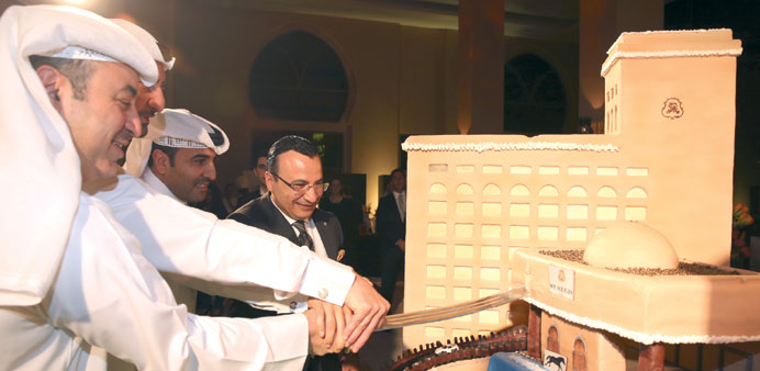Omar Alfardan cuts a cake during the celebrations.