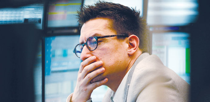 A trader reacts as he monitors financial data on his computer screen at the Frankfurt Stock Exchange. The Dax 30 retreated 0.41% to 8,201.05 points in