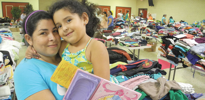 STRUGGLE: Karla Lara, left, and daughter Dalisei at the Sacred Heart Church welfare centre in McAllen, Texas. Lara was waiting to leave for Chicago by
