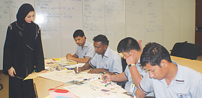 A student tutor teaches workers.