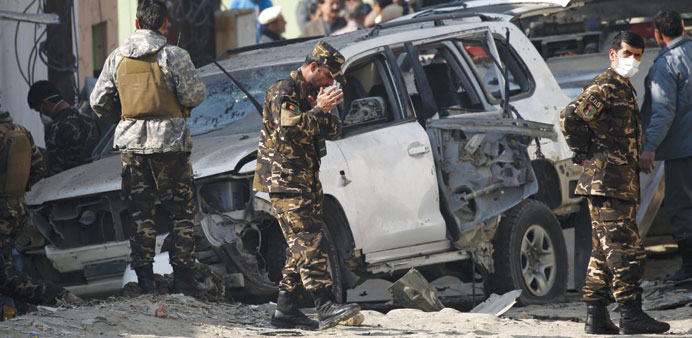 Afghan security personnel keep watch at the site of a suicide blast that targeted a senior member of Afghanistanu2019s election commission in Kabul yester
