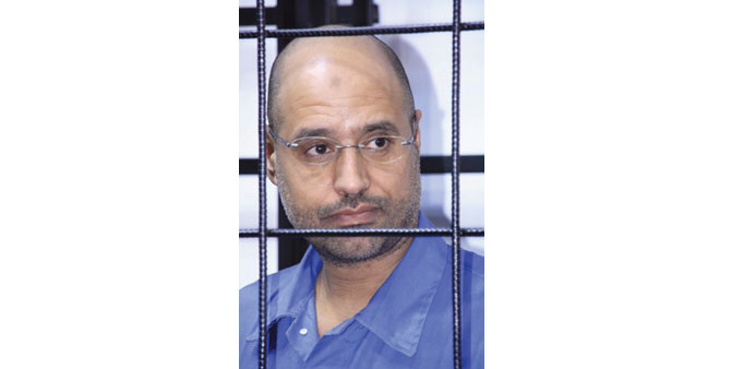Saif al-Islam attends a hearing behind bars in a courtroom in Zintan in this May 15, 2014 file photo.