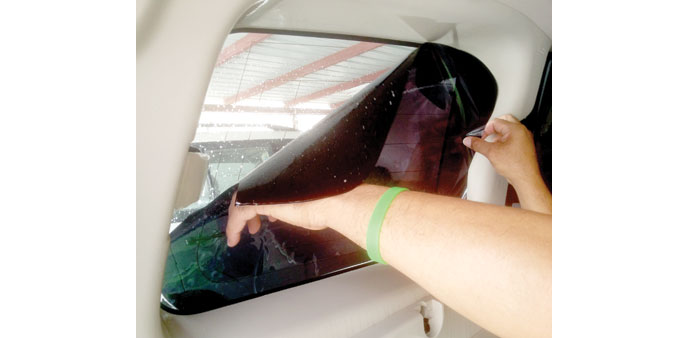 New tint film is applied onto a rear window of a vehicle. PICTURE: Peter Alagos