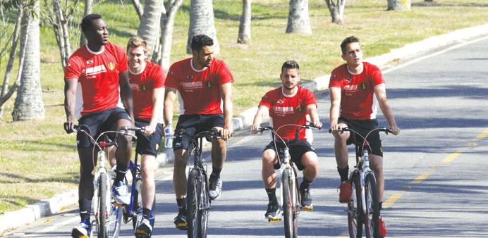 Belgium players (from left) Romelu Lukaku, Nicolas Lombaerts, Nacer Chadli, Dries Mertens and Adnan Januzaj ride bikes as they arrive for the training