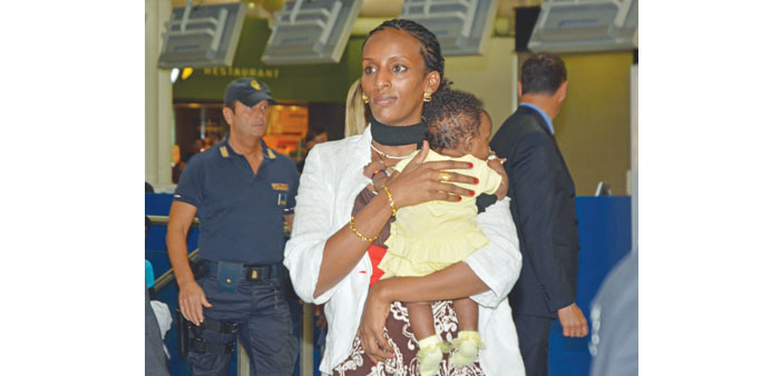 Ishag with her daughter Maya in her arms at Romeu2019s Fiumicino Airport before leaving for Philadelphia.