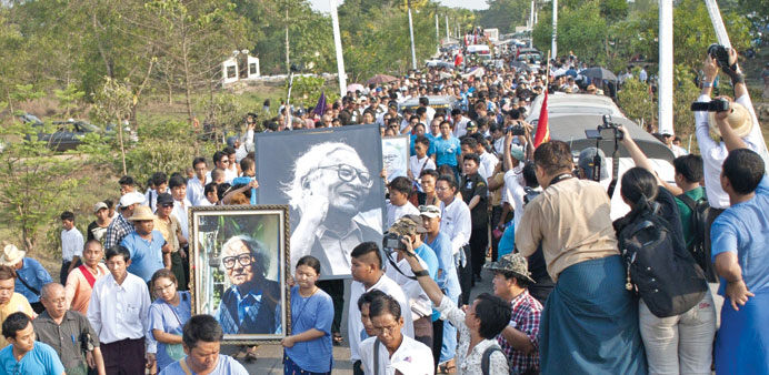 Supporters gather around the coffin of activist Win Tin during his funeral ceremony in Yangon yesterday.