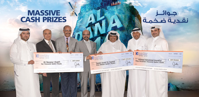Winners of Doha Banku2019s Al Dana Savings Programme with officials.