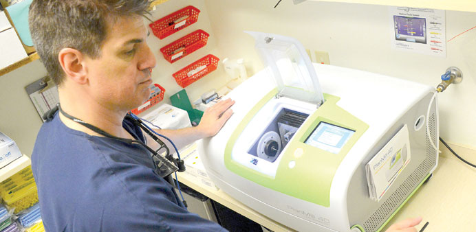 FAST TRACK: Dr Rick Rivardo operates a Plan Mill milling unit at his office. The new 3D imaging technology enables dentists to do procedures, such as 