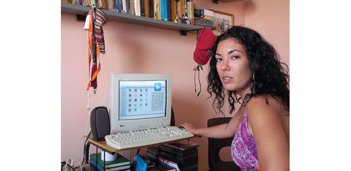 Yaima Pardo, 34, in her home in Cuba as she describes her project PaSA (Paquete Semanal Autnomo), an independent weekly digital-media package for Cuba