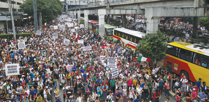 Thousands of protesters belonging to the Iglesia ni Cristo (Church of Christ) group march along Edsa highway in Mandaluyong, Metro Manila yesterday.