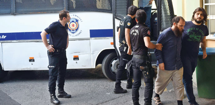 Turkish police officers escort suspected members of the Islamic State group to a hospital for a medical check-up in Istanbul.