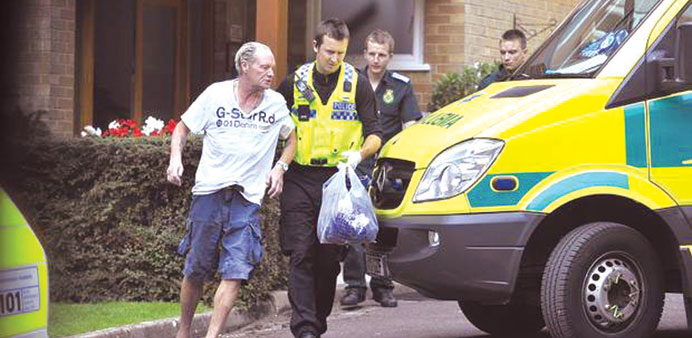 A gaunt Paul Gascoigne is escorted to an ambulance after he was found slumped outside his home.
