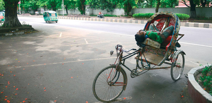A rickshaw-puller sleeps during a nationwide strike called by the opposition Bangladesh Nationalist Party (BNP) in Dhaka yesterday.