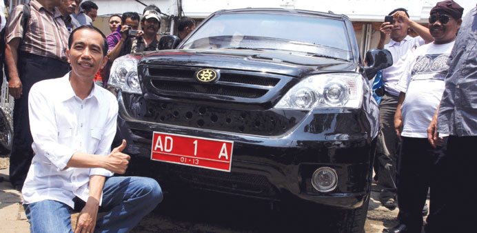 File photo shows then-mayor of Solo, Joko Widodo posing with a locally made Esemka car.