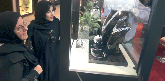  Women look at jewellery during an exhibition at Al Faisaliah hotel in Riyadh yesterday.